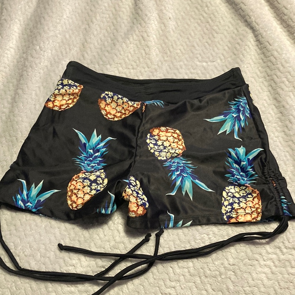 Black base with pineapple design swim bottoms
